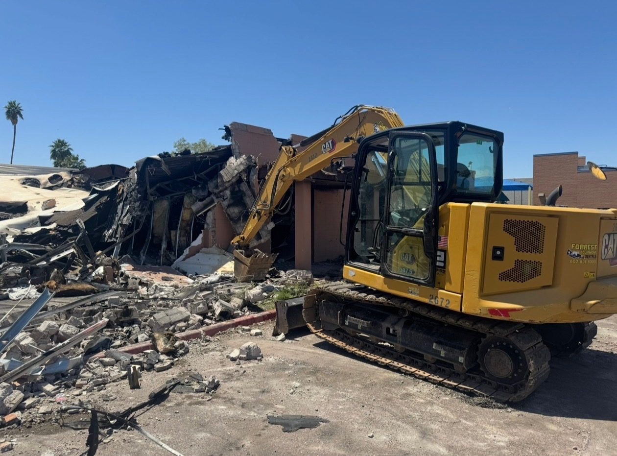 CAT excavator demolishing a commercial building in the Phoenix area