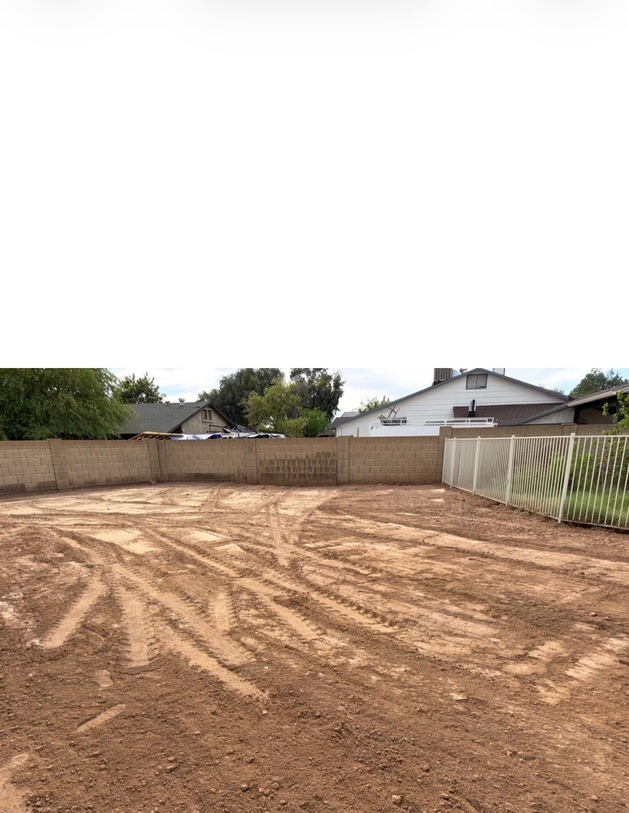 The same backyard after pool removal — filled, compacted, and graded clean